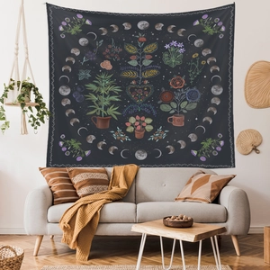 Bohemian wall tapestry with moon phases and life tree above a modern living room sofa