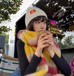 Winter warming set featuring a yellow-pink plaid scarf and a white knit beanie with a red label