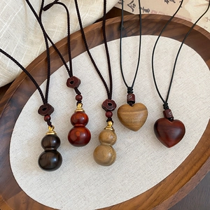 Ethnic wood gourd and heart pendant necklaces with wax cord on vintage linen base