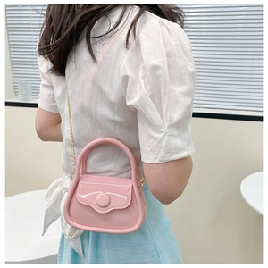 Pink jelly mini bag with gold chain strap shown being worn by a model in lifestyle shot