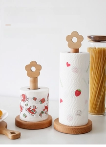 Detail of wooden paper towel holder featuring a unique flower top and natural beech texture
