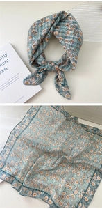 Detailed view of light blue daisy print cotton linen scarf with sheer mesh texture