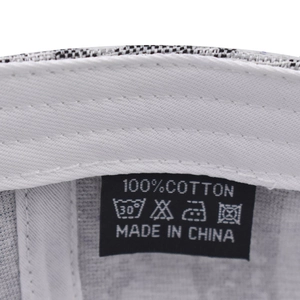 Close-up of the cotton sweatband and care label inside the plaid baseball cap