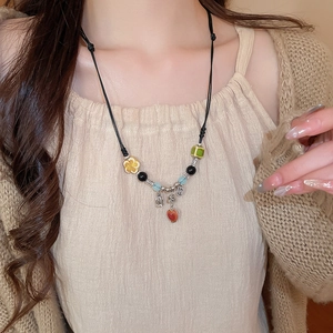 Detailed close-up of a Neo-Chinese style beaded necklace with ceramic apple pendant
