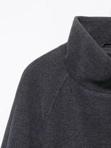 Detailed view of the dark grey knit fabric texture on the stand-up collar and shoulder