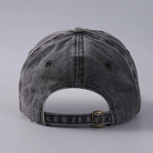 Detail of washed cotton denim baseball cap with vintage metal buckle adjustment