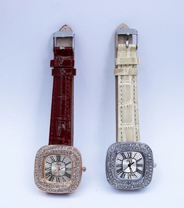 Close-up of luxury square quartz watches with diamond bezels and leather straps