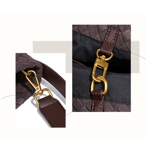 Detailed close-up of dark brown woven texture with leather strap and golden buckle