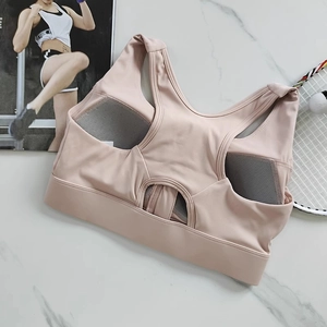Detail of racerback sports bra in dusty pink with breathable mesh and cutout design