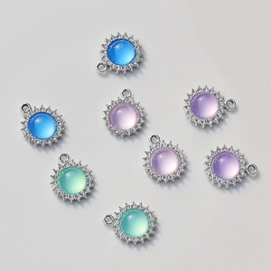 Macro detail of sunflower evil eye charms with colorful gemstones and white zircons