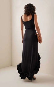 Slim fit black sleeveless maxi dress with dramatic ruffle hem and elegant open back design