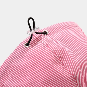 Detail of pink striped sun hat featuring adjustable black elastic drawstring and metal eyelets