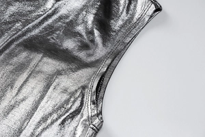 Detail of silver metallic dress showing the side seam construction and armhole tailoring