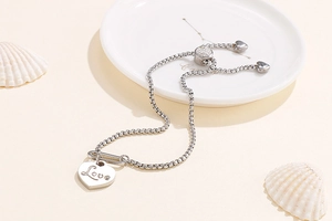 Detail of silver box chain bracelet with heart Love pendant and adjustable sliding clasp