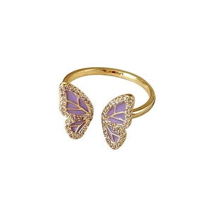 Elegant gold butterfly ring with purple enamel wings and shimmering crystal details
