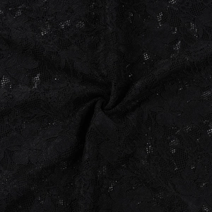 Close-up of elegant black floral lace fabric with detailed sheer mesh and texture