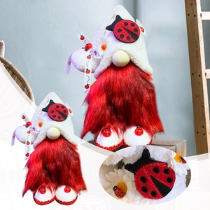 Detail of ladybug gnome with long red beard and white hat decorated with small insects