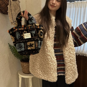Detail of plush geometric knit handbag with colorful blocks and sozakka logo label