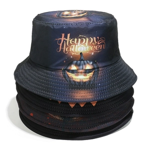 Detail of stacked Halloween bucket hats with pumpkin prints and star sky texture