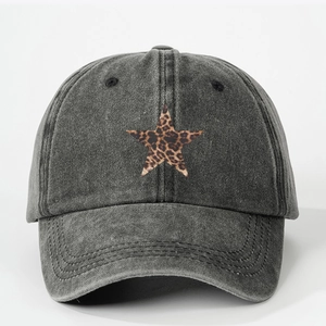 Detailed texture of washed denim baseball cap with a leopard print star patch