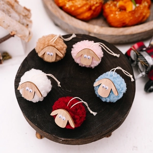 Five colorful handmade wool felt sheep ornaments with wooden heads on a dark base