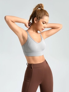 Cross-back grey sports bra and high-waist brown yoga leggings for workout and fitness