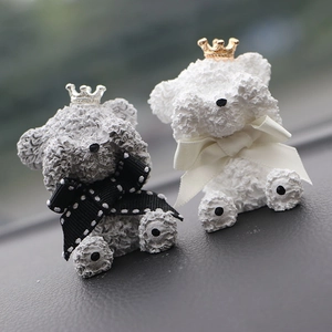 Detail of gray and white crown teddy bear car air vent clips with ribbon bows