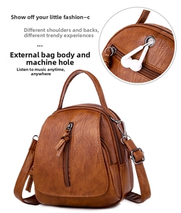 Detail showing the external headphone jack on a soft brown faux leather shoulder bag