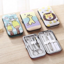 Detail of cartoon animal manicure set featuring metal nail clippers and grooming tools