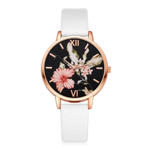 Detail of rose gold quartz watch featuring a floral dial with pink hibiscus and white flowers