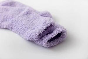 Close-up of soft purple coral fleece winter sock showing warm plush texture and cuff detail