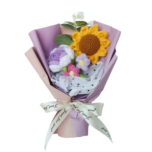 Handmade crochet sunflower and purple rose bouquet wrapped in pink paper for graduation gift