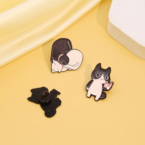 Detail of cute enamel cat brooches featuring reading and hugging kitten designs