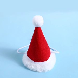Detailed close-up of a red felt Christmas hat for pets with fluffy white trim and elastic strap