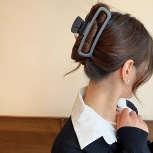 Elegant matte black rectangle hair claw clip shown on model for thick hair styling