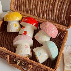 Handcrafted ceramic mushroom night lights in colorful glazes set in a woven basket
