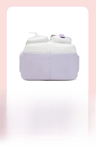 Close-up of bottom stitching and buckle detail on the purple and white canvas backpack