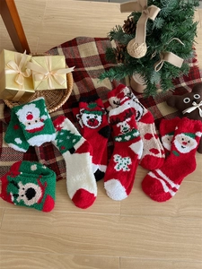 Detail of plush coral fleece Christmas socks featuring soft textures and festive patterns