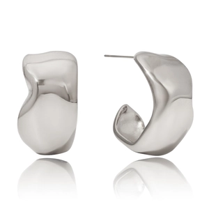 Detail of silver irregular C-shaped earrings with organic molten texture finish