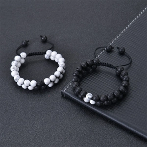 Macro shot of double-layer woven bracelets with matte lava stone and white marble beads