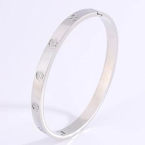 Detailed macro view of the silver stainless steel bangle with solar floral engraving pattern