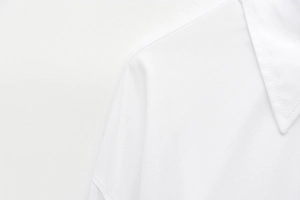 Close-up of white twill shirt collar featuring double-stitched sewing details and texture