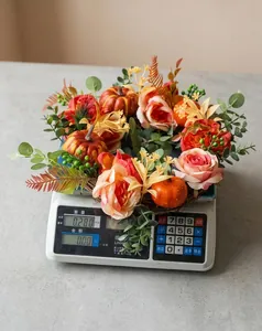 Detail view of fall pumpkin and rose wreath weighing 0.280kg on an electronic scale