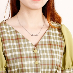 Minimalist silver stainless steel heartbeat pendant necklace for women shown on a model