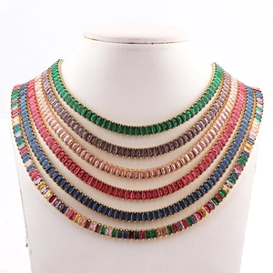 Close-up of stacked necklaces with colorful rectangular zircon stones on a white bust