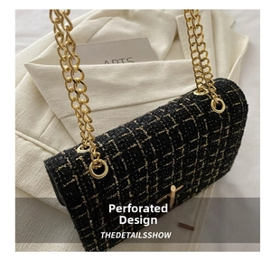 Close-up of black and gold tweed texture with a rotating metal lock on a chain bag