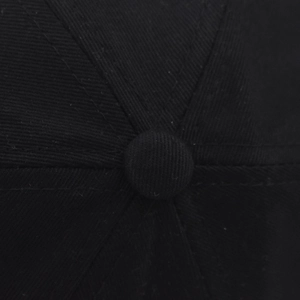 Macro shot of the button and cotton twill stitching on the black vintage baseball cap