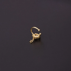 Golden ear cuff with purple gemstone and hanging star pendant on dark background