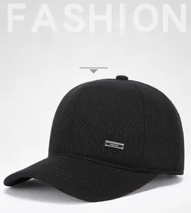 Detail view of black thermal earflap cap with a FASHION metal plaque and knit texture