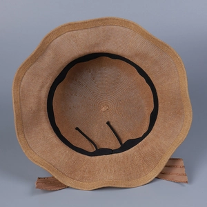 Detail view of the breathable straw hat interior with adjustable strap and sweatband